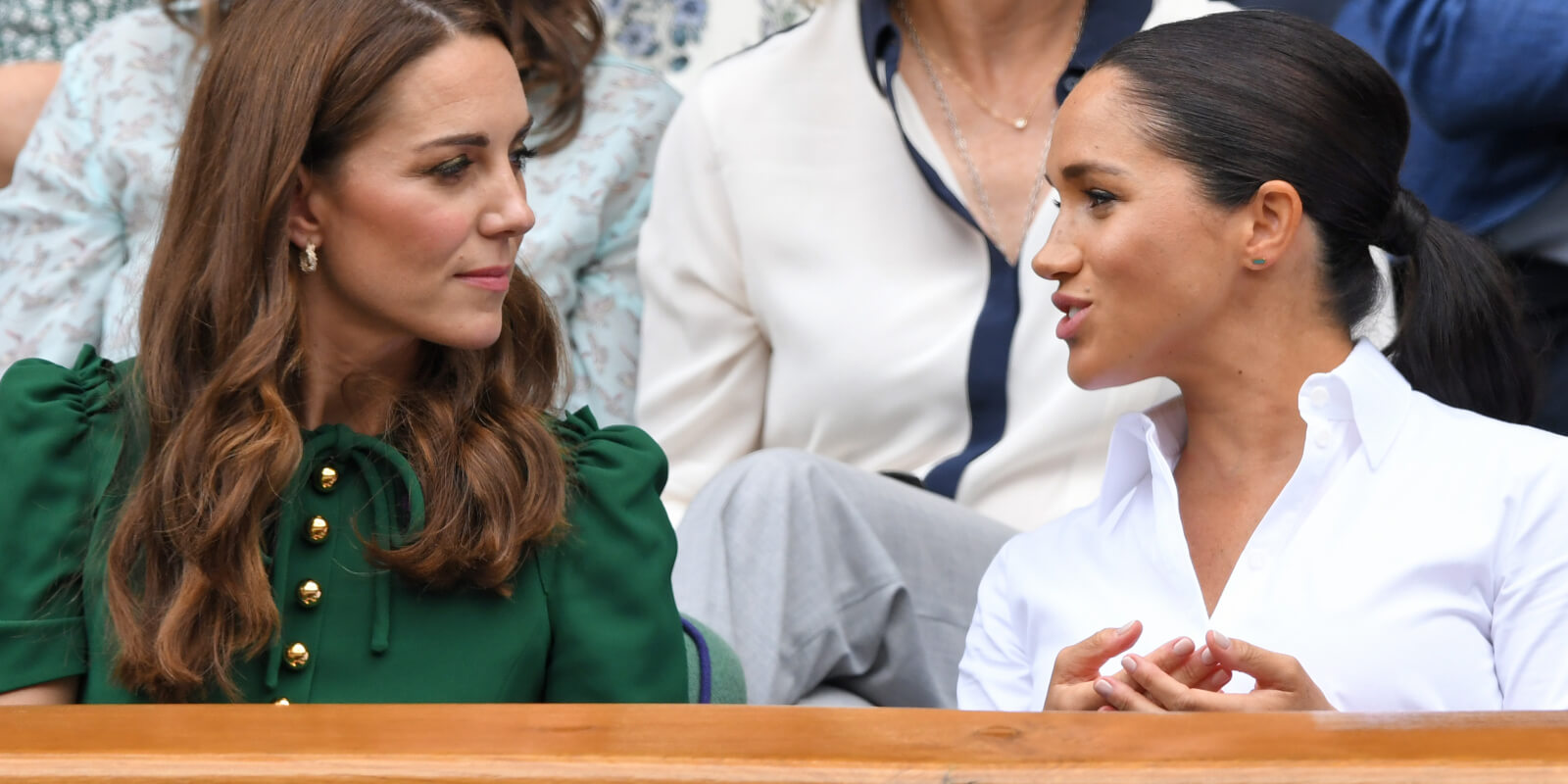 Kate Middleton and Meghan Markle seated at Wimbledon Tennis Championships in 2019.