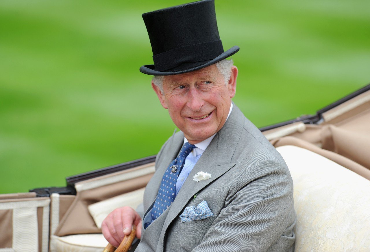 King Charles sits in a horse-drawn carriage during a royal engagement. 