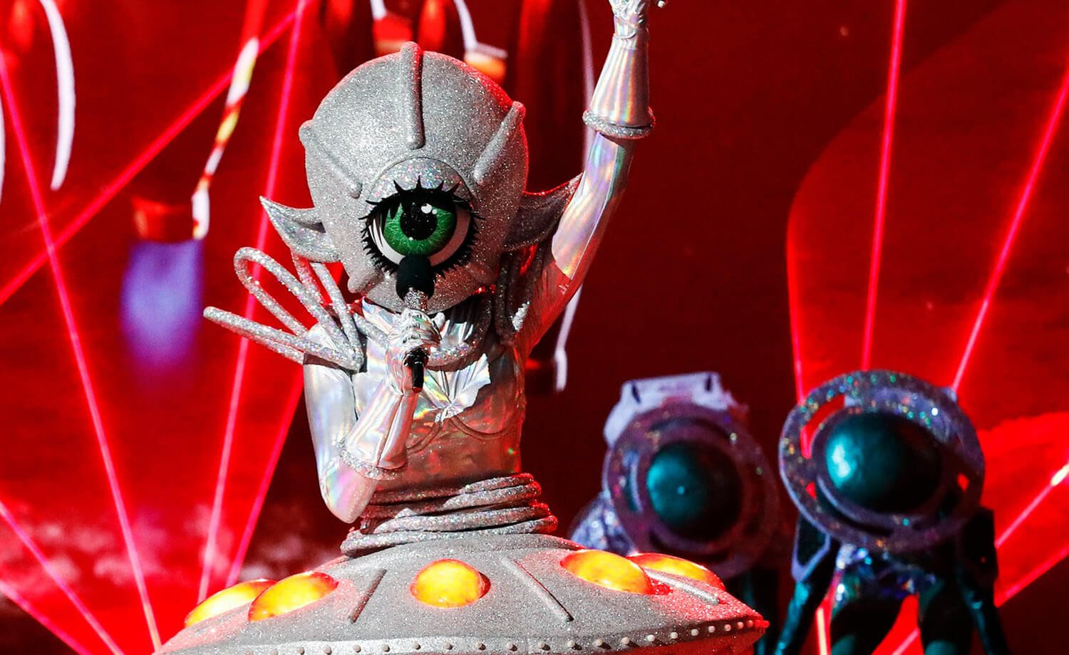 UFO sings with one arm pointed to the sky on The Masked Singer Season 9's Space Night
