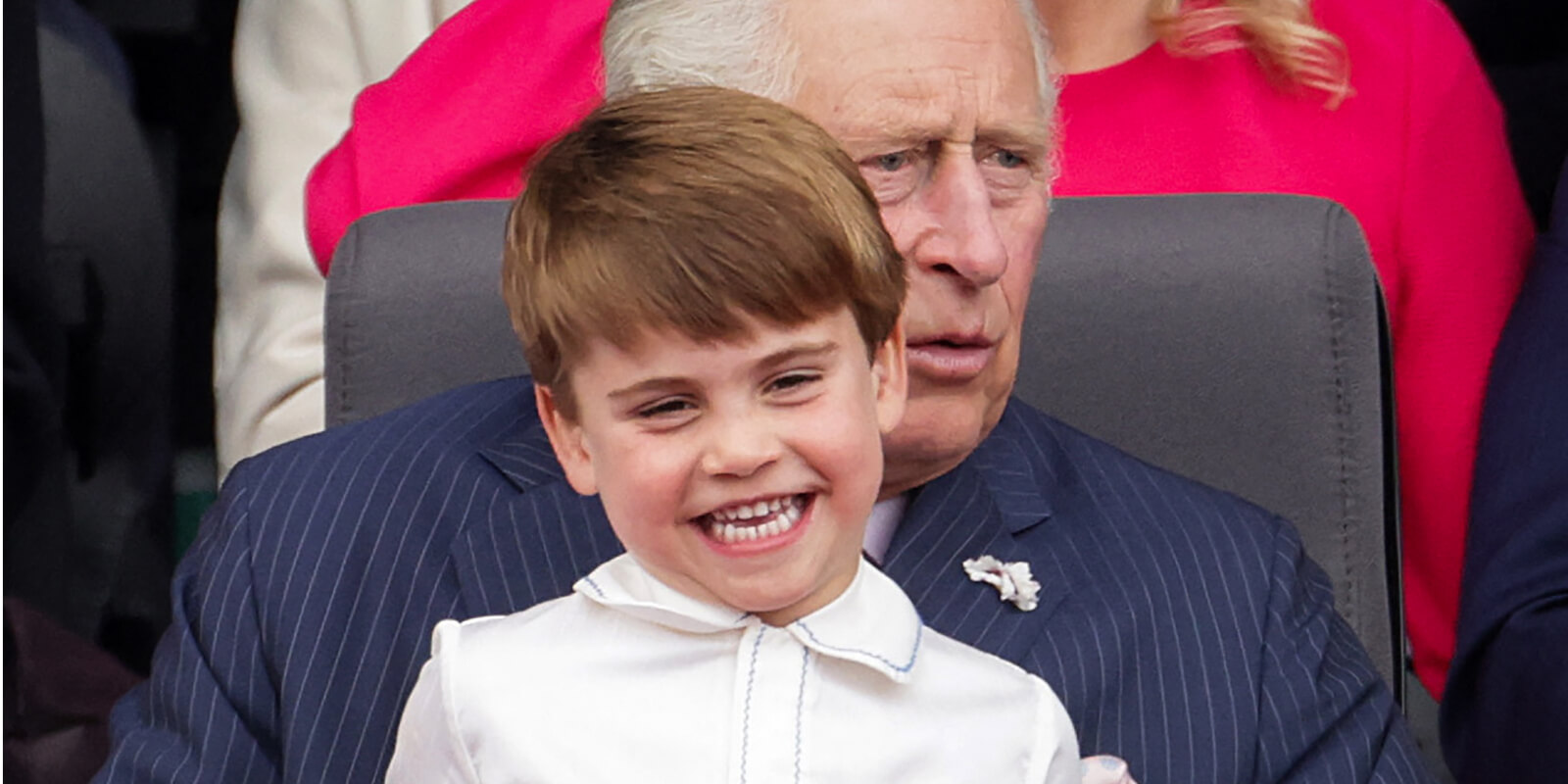 Prince Louis sits on the lap of his grandfather King Charles III during a royal event in 2022.