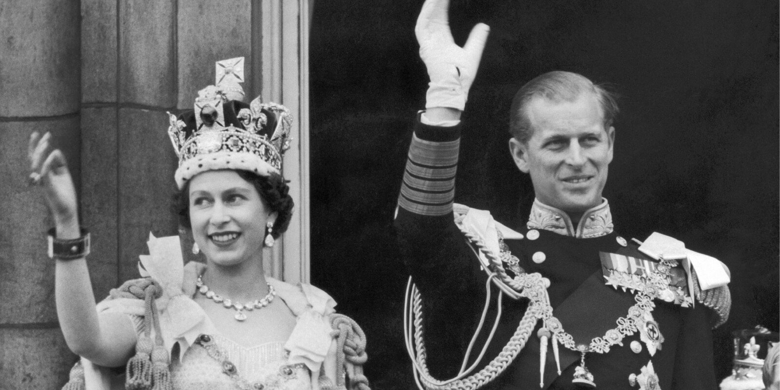 The coronation ring can be seen on Queen Elizabeth's right hand as she and Prince Philip wave to crowds from the Buckingham Palace balcony in 1953.