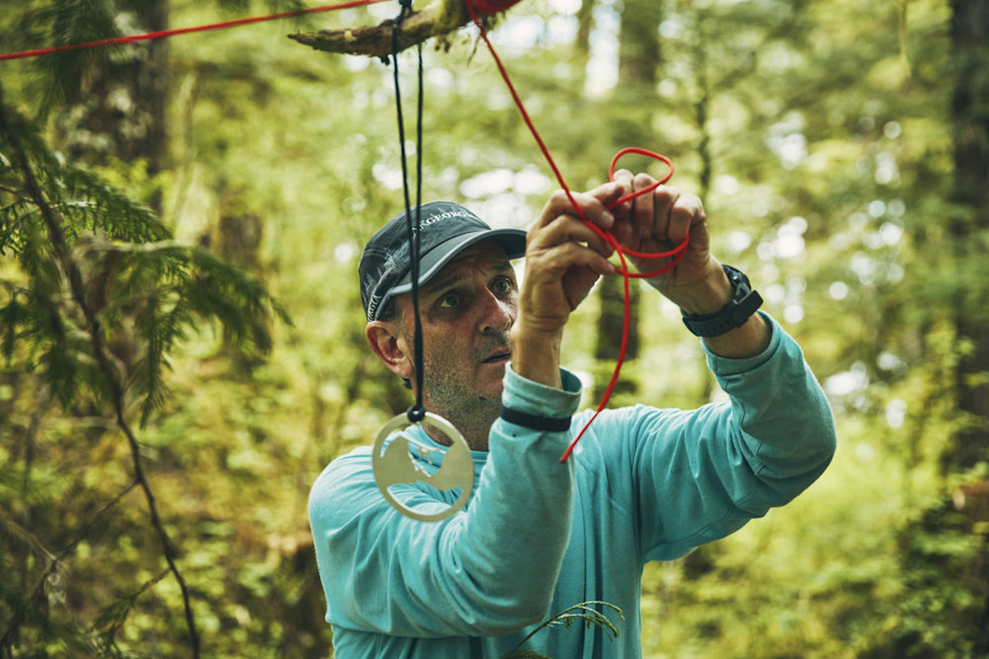 Jeff Leininger ties a medal to a tree