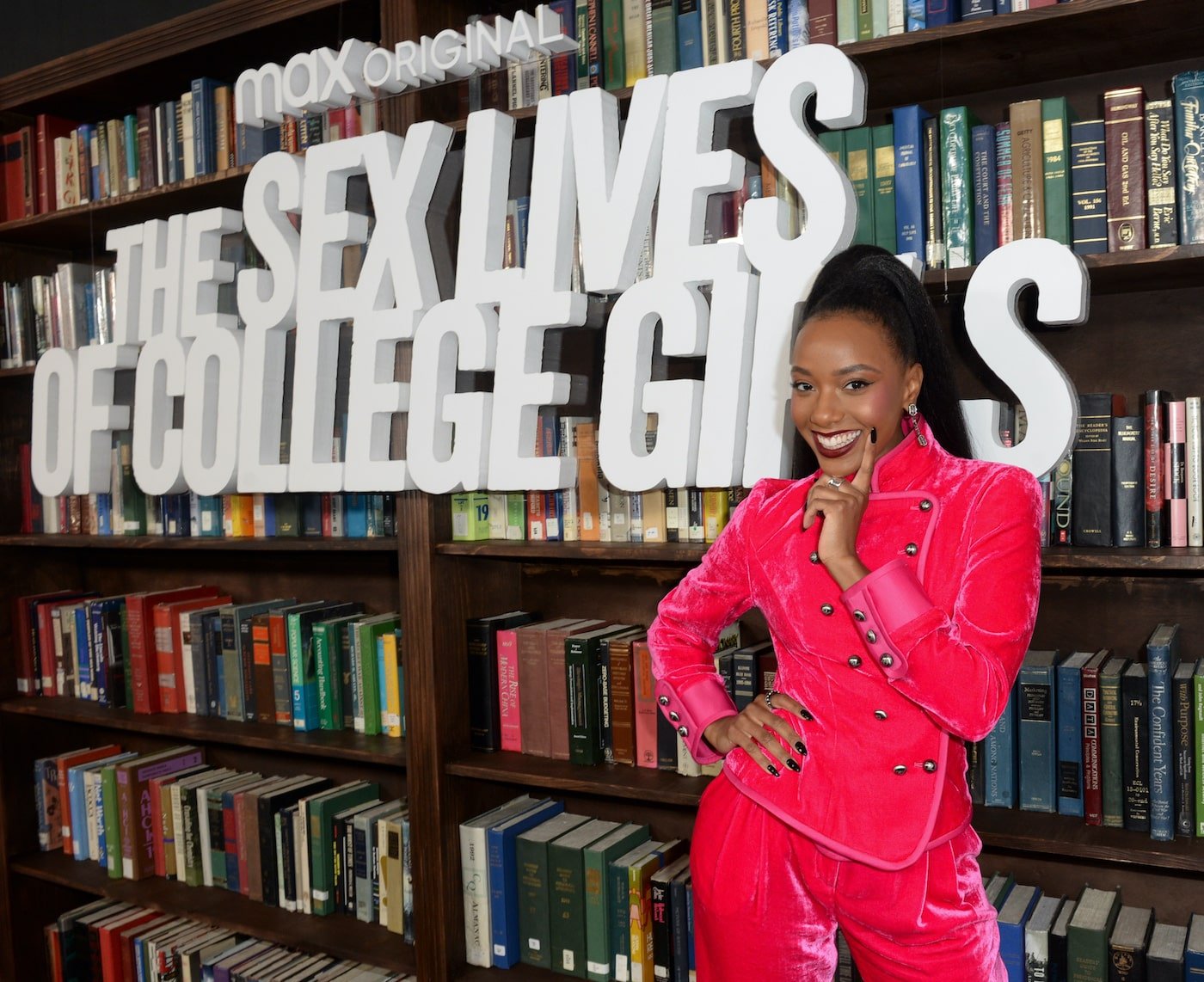 Alyah Chanelle Scott wearing a red suit at the premiere of 'The Sex Lives of College Girls'