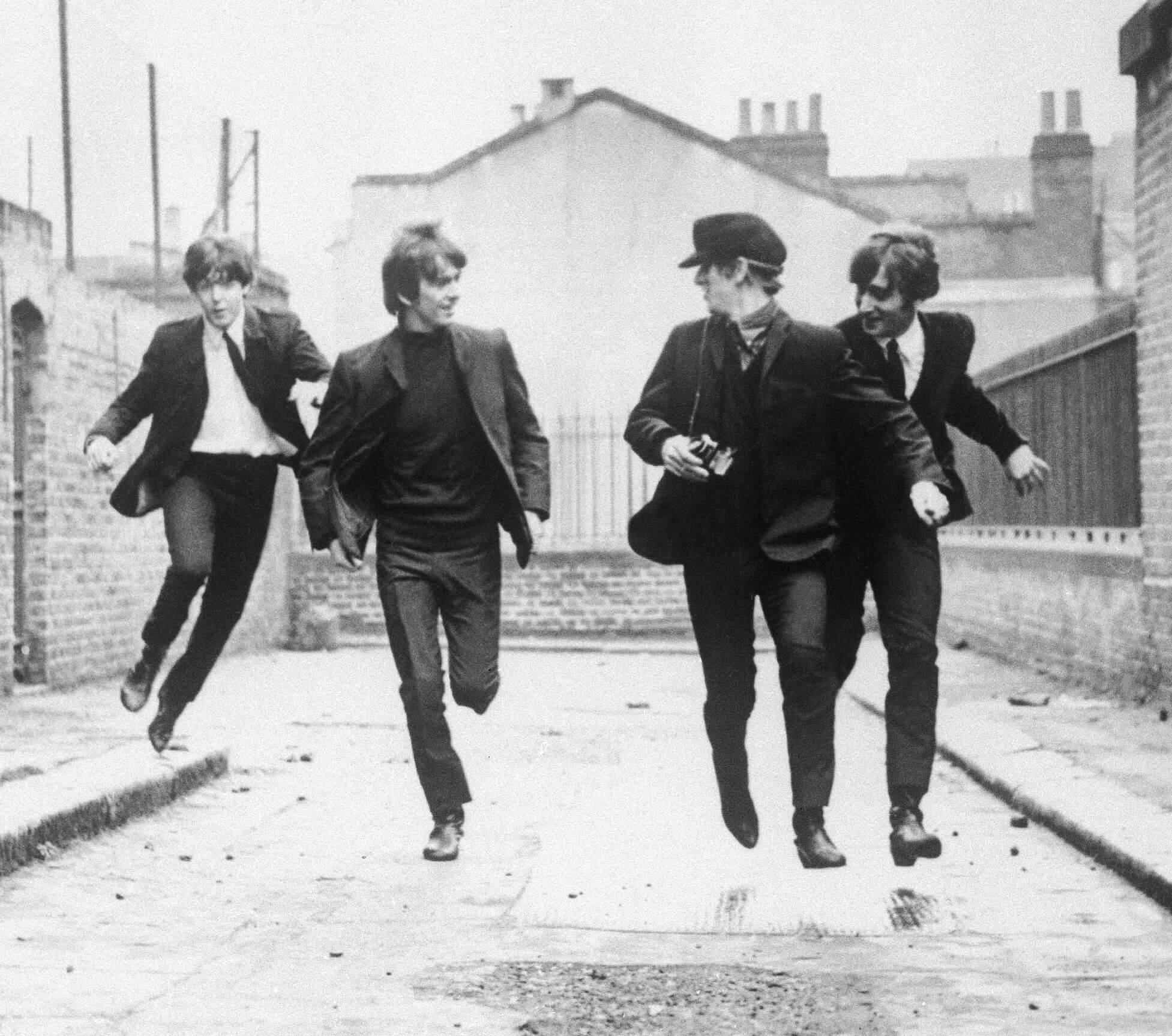 The Beatles running during the "She Loves You" era