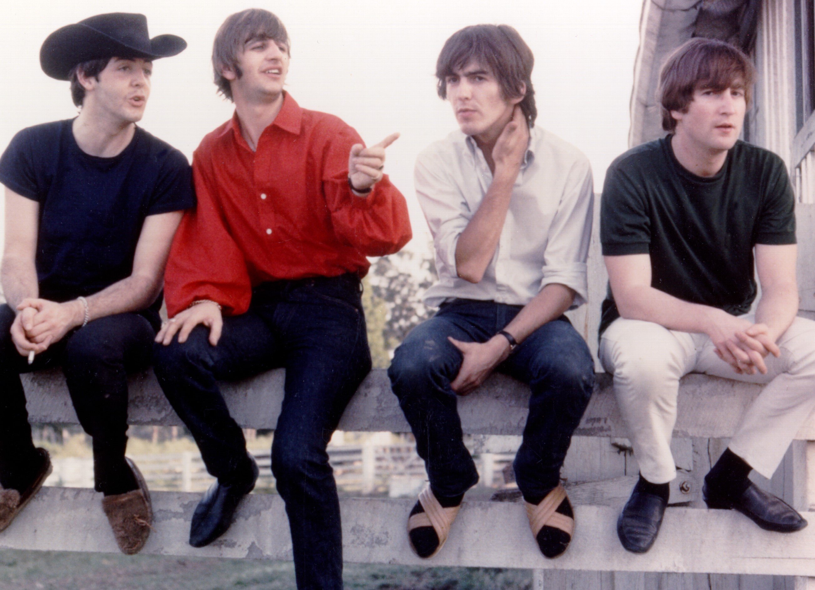 The Beatles on a fence during the 'Magical Mystery Tour' era