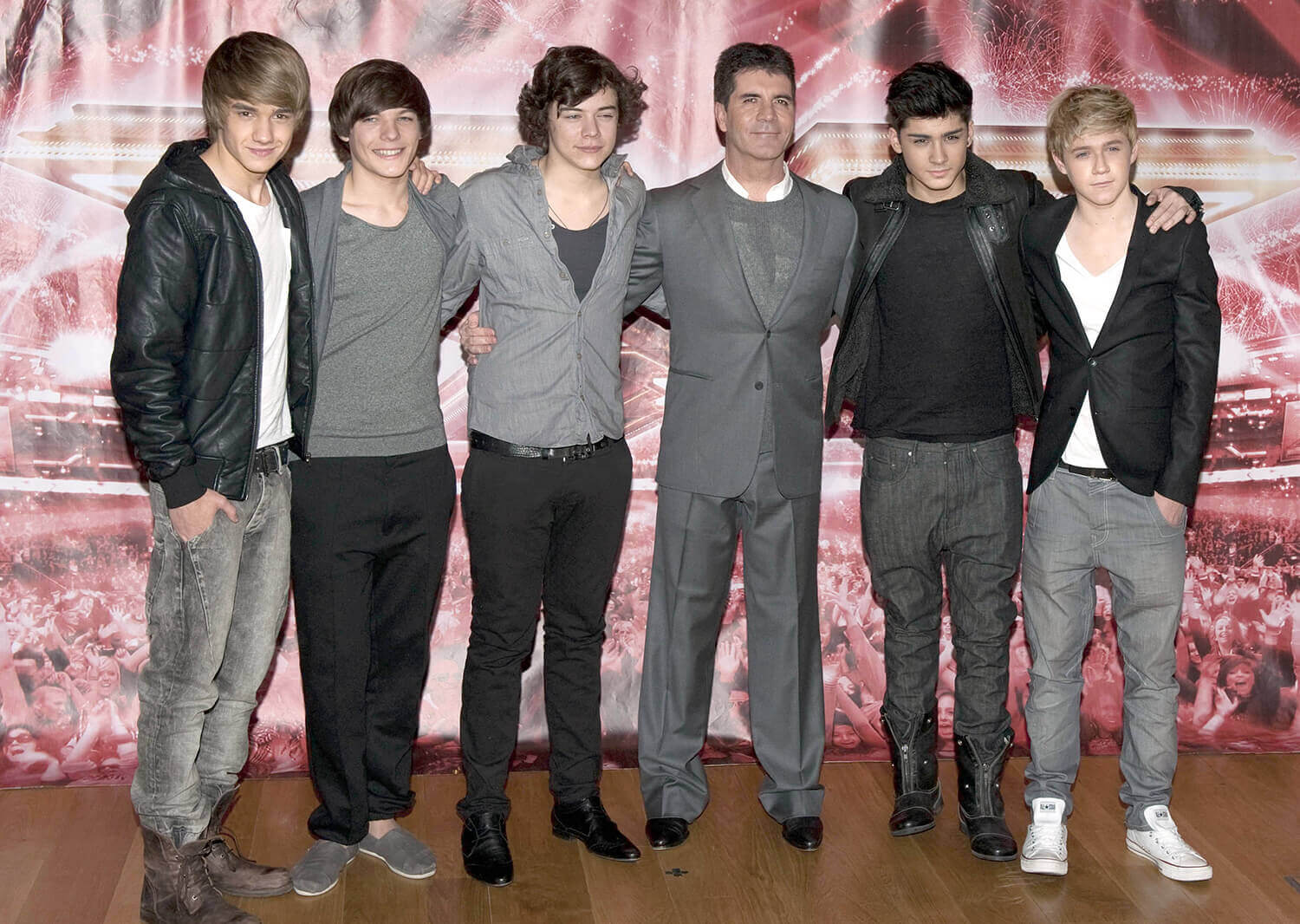 Liam Payne, Louis Tomlinson, Harry Styles, Simon Cowell, Zayn Malik, and Niall Horan pose together at a press conference for The X Factor in 2010