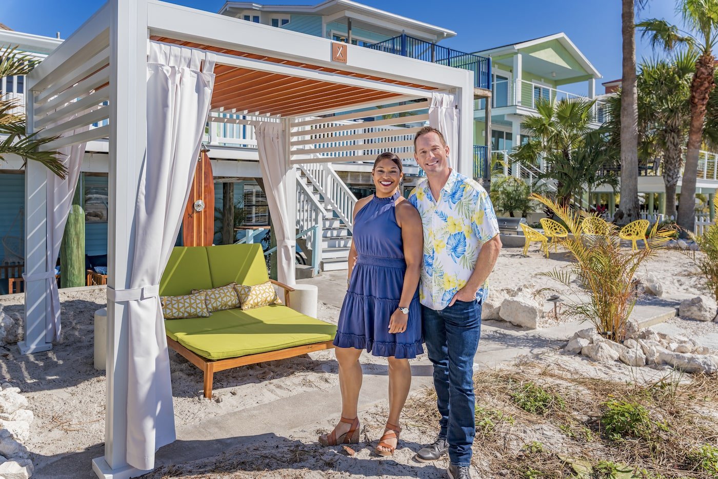 Brian and Mika Kleinschmidt from '100 Day Dream Home' stand on a beach