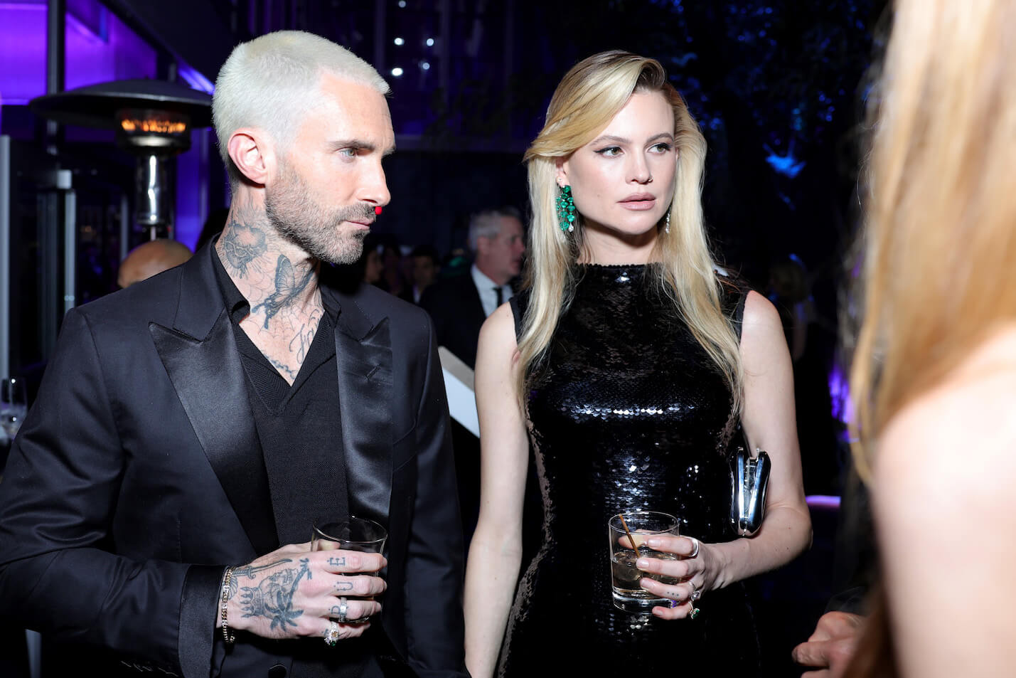 Adam Levine and Behati Prinsloo standing next to each other at an event