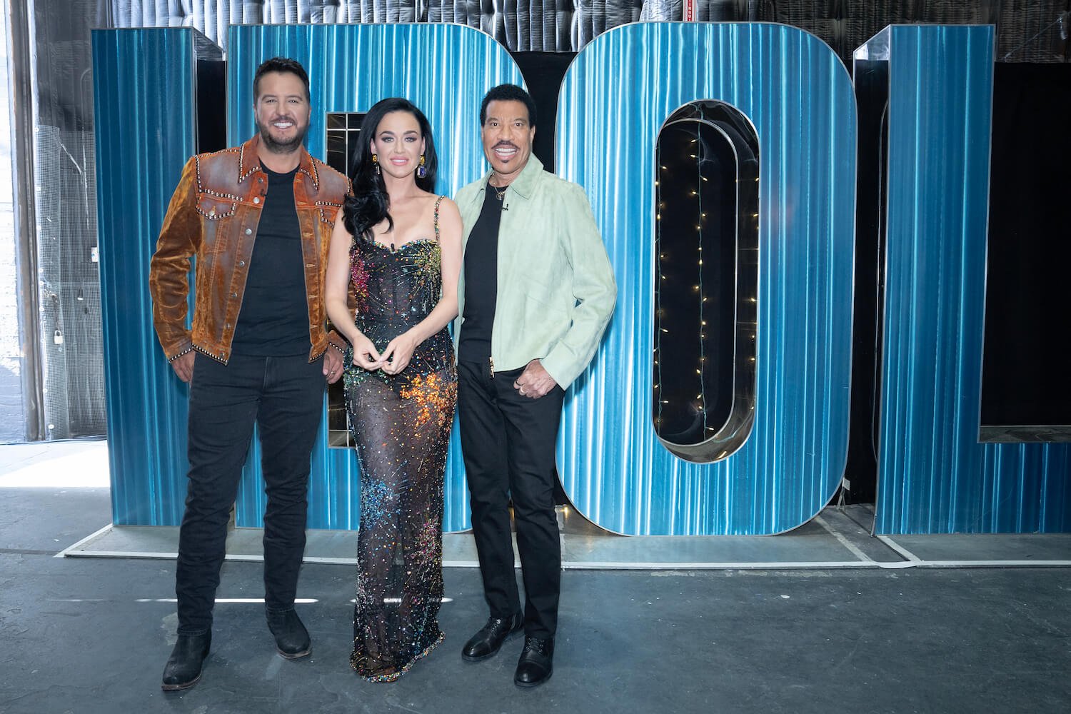 'American Idol' 2023 judges Luke Bryan, Katy Perry, and Lionel Richie standing next to each other and smiling