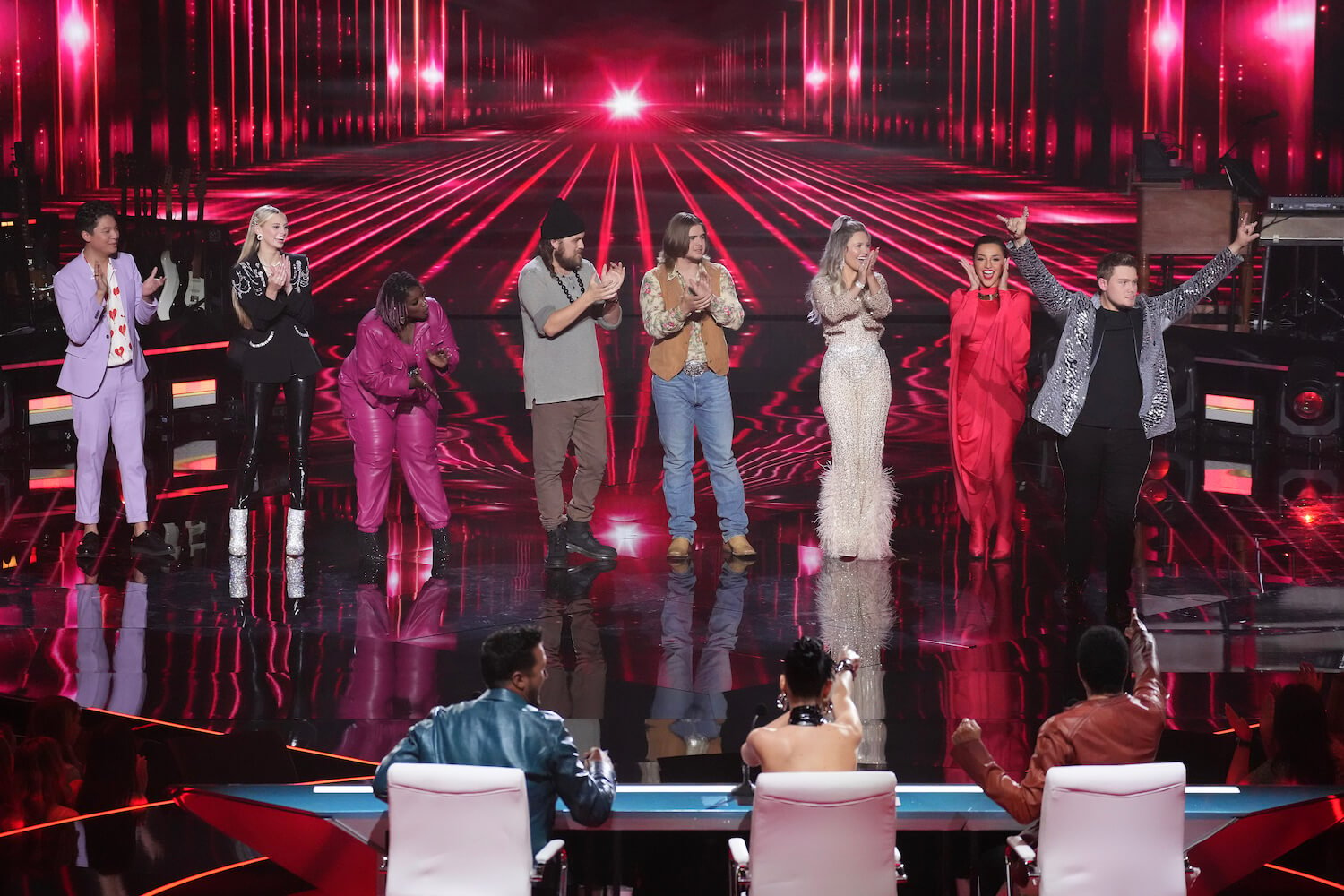 The 'American Idol' 2023 top 10 contestants on stage against pink lighting