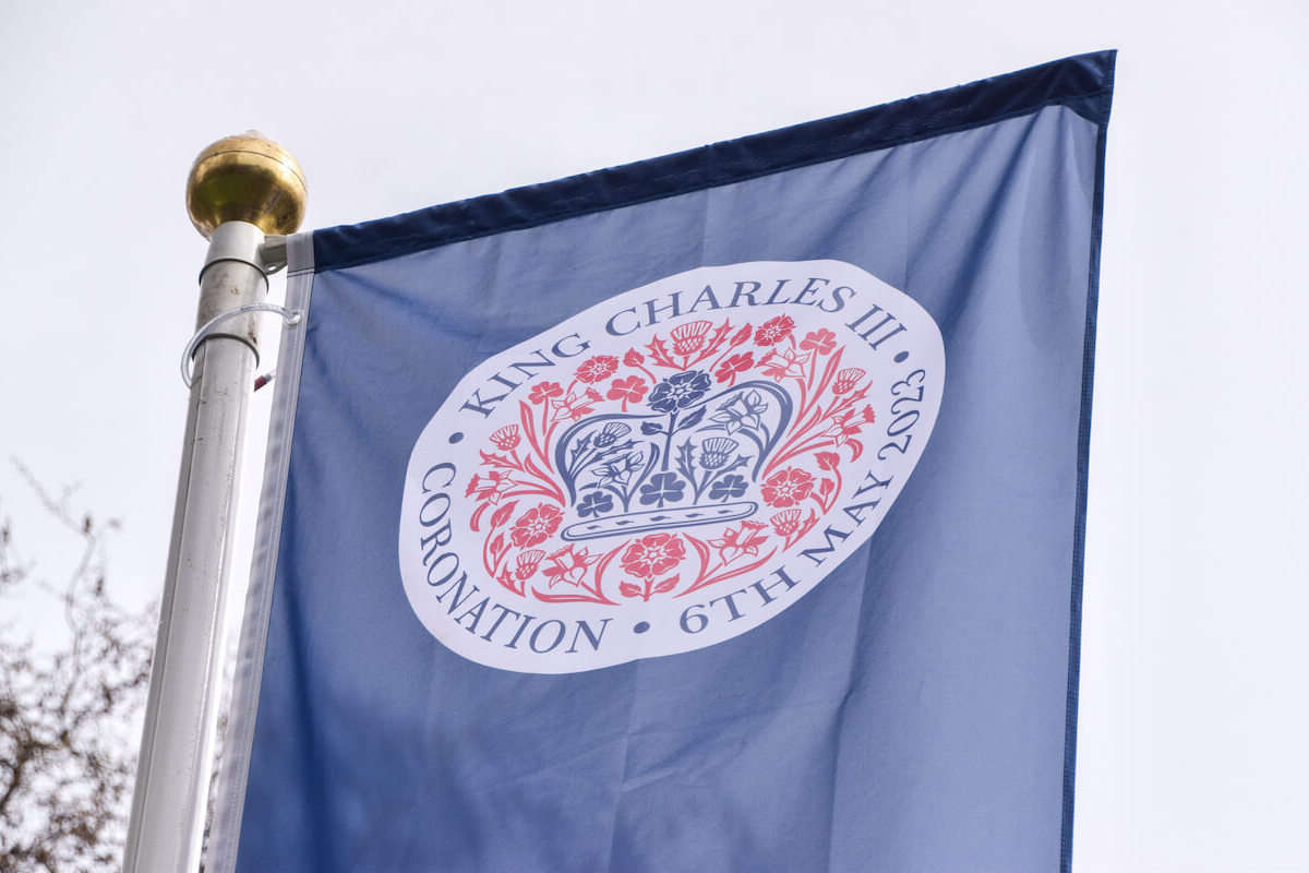 A banner for King Charles III's coronation, of which security has been attributed as the bulk of the cost, flies in London, England