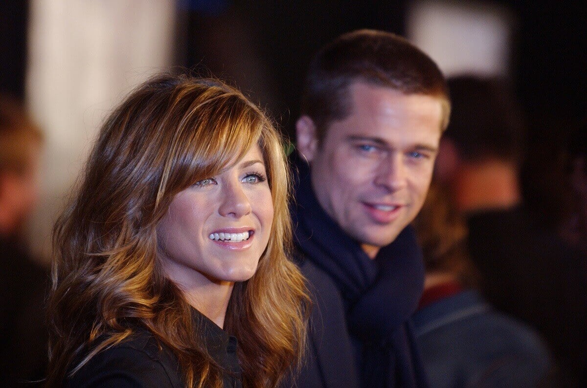 Brad Pitt and Jennifer Aniston taking a picture at the premiere of the movie 'Troy'.