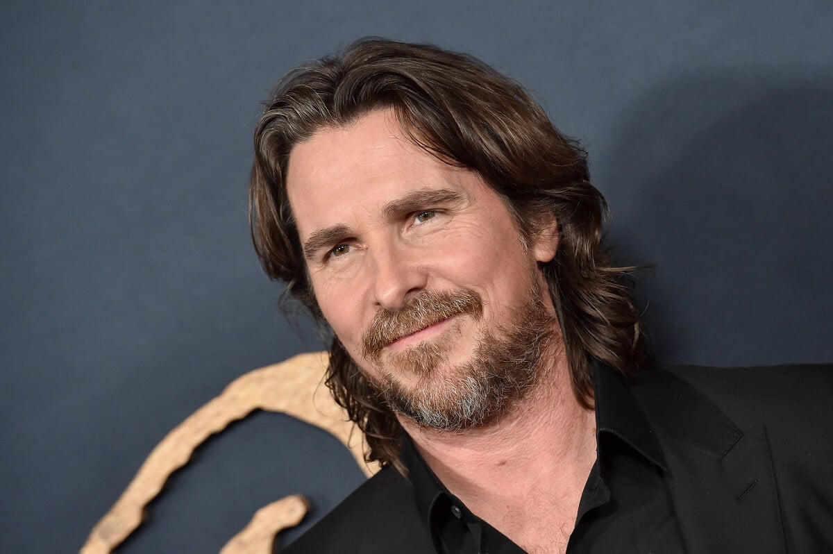 Christian Bale smiling while taking a picture at the 'The Pale Blue Eye' Los Angeles Premiere.