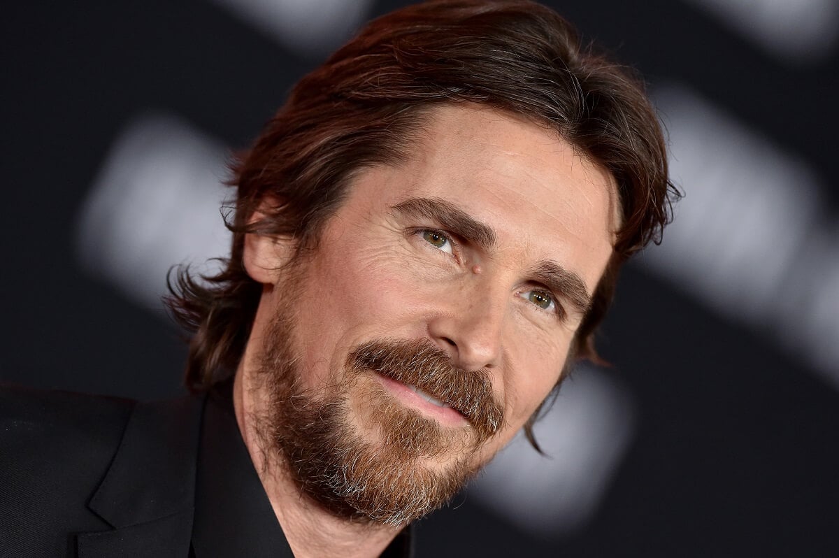 Christian Bale posing while taking a picture at the 'Ford v Ferrari' premiere.