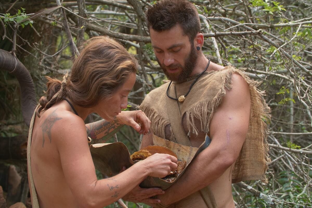 Cheeny and Dan looking at a honeycomb on 'Naked and Afraid: Last One Standing' on Discovery Channel