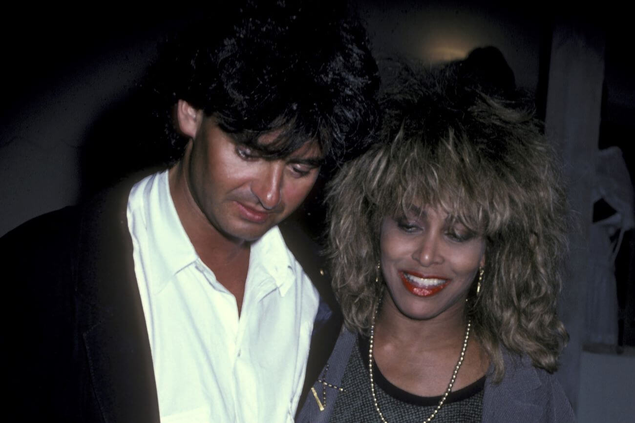 Erwin Bach wears a white shirt and Tina Turner wears a silver jacket and a necklace.