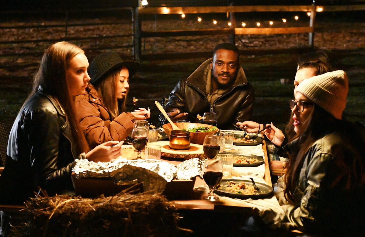 Ryan from 'Farmer Wants a Wife' sitting at a table outside with several women