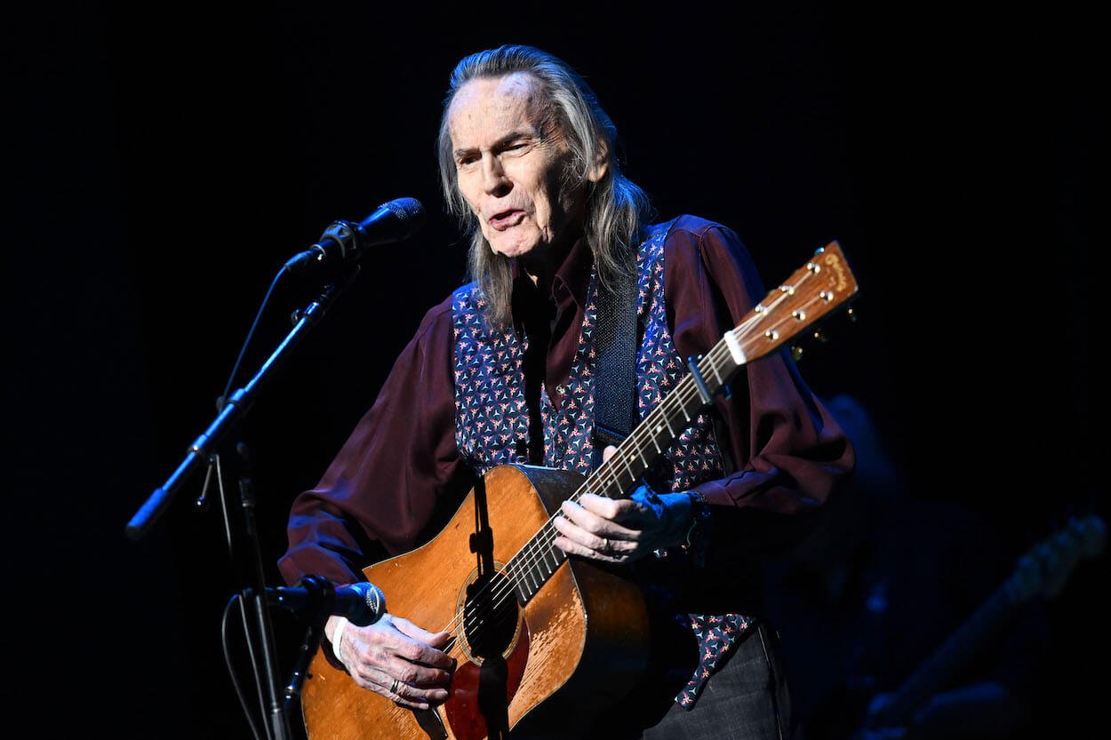 Gordon Lightfoot plays an acoustic guitar and sings during a 2019 concert in Beverly Hills, California.