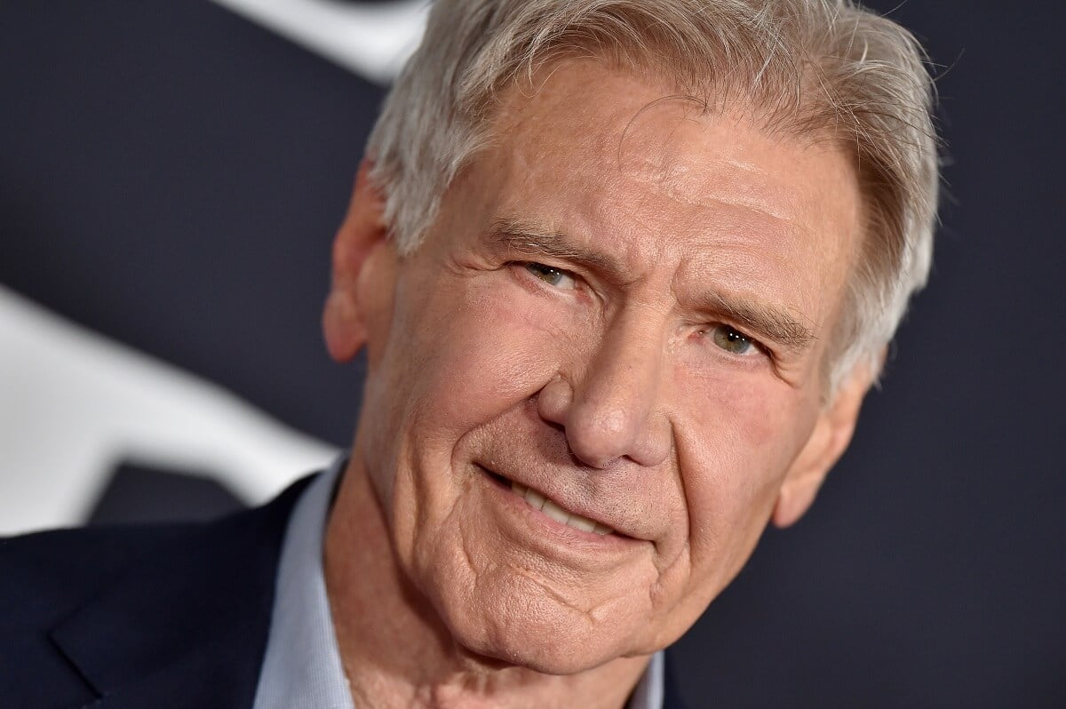 Harrison Ford smirking and taking a picture at the 'The Call of the Wild' premiere.