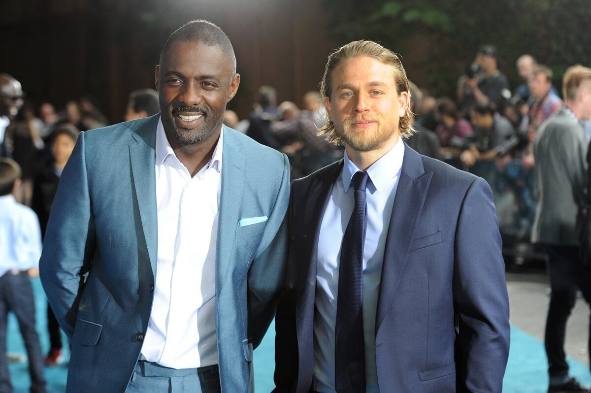 Idris Elba and Charlie Hunnam smiling in suits as they attend the European premiere of 'Pacific Rim'.