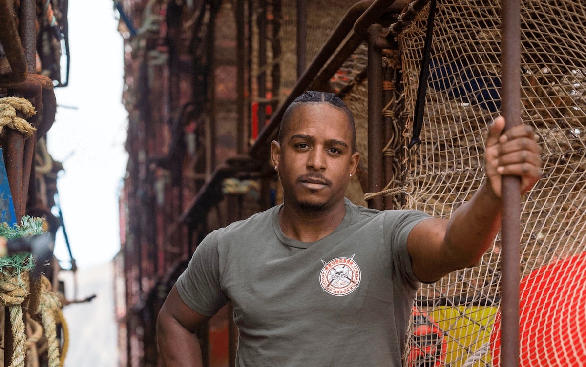 'Deadliest Catch' cast member Jacob Hutchins posing in front of crab pots