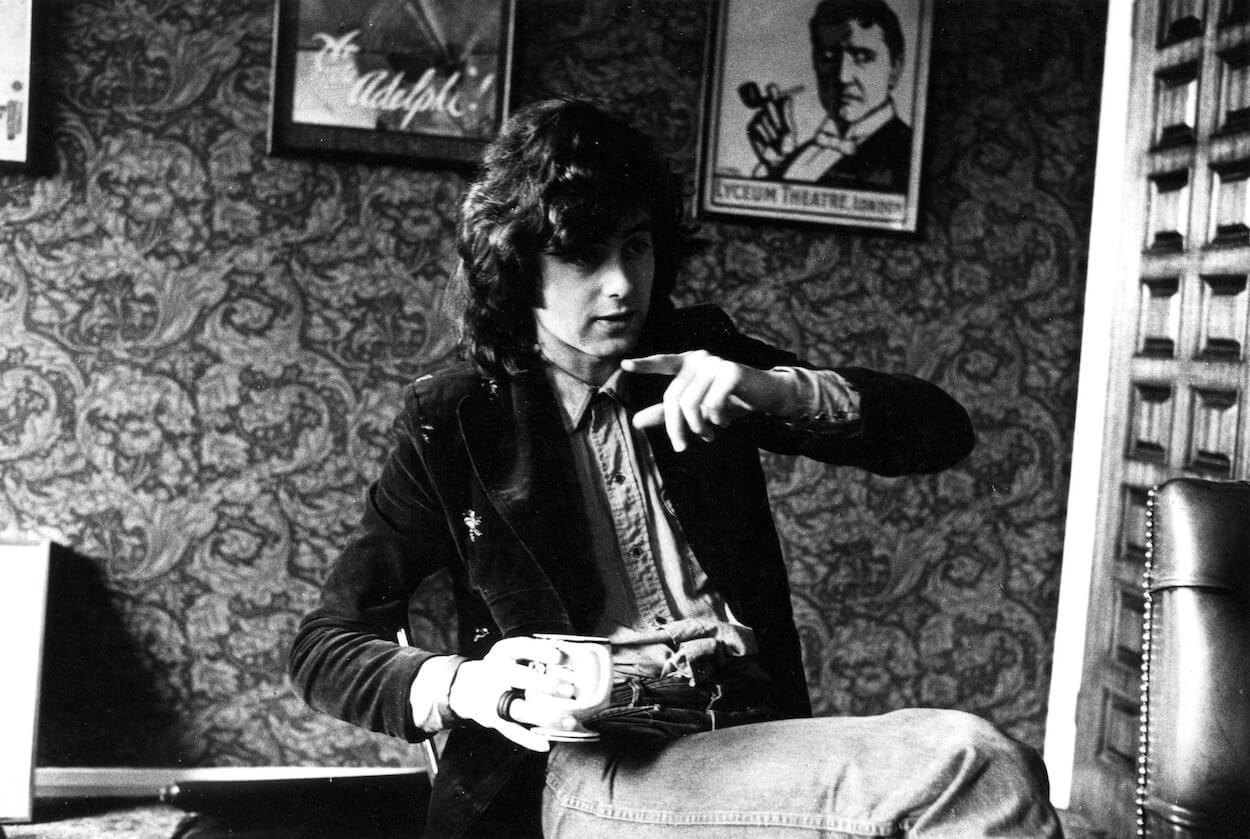 Led Zeppelin guitarist Jimmy Page pointing with his left hand while holding a coffee mug in his right hand in 1973.