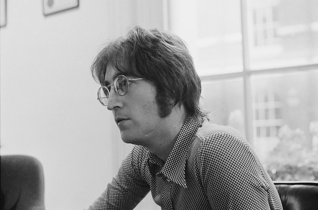 John Lennon's profile photographed in black and white.