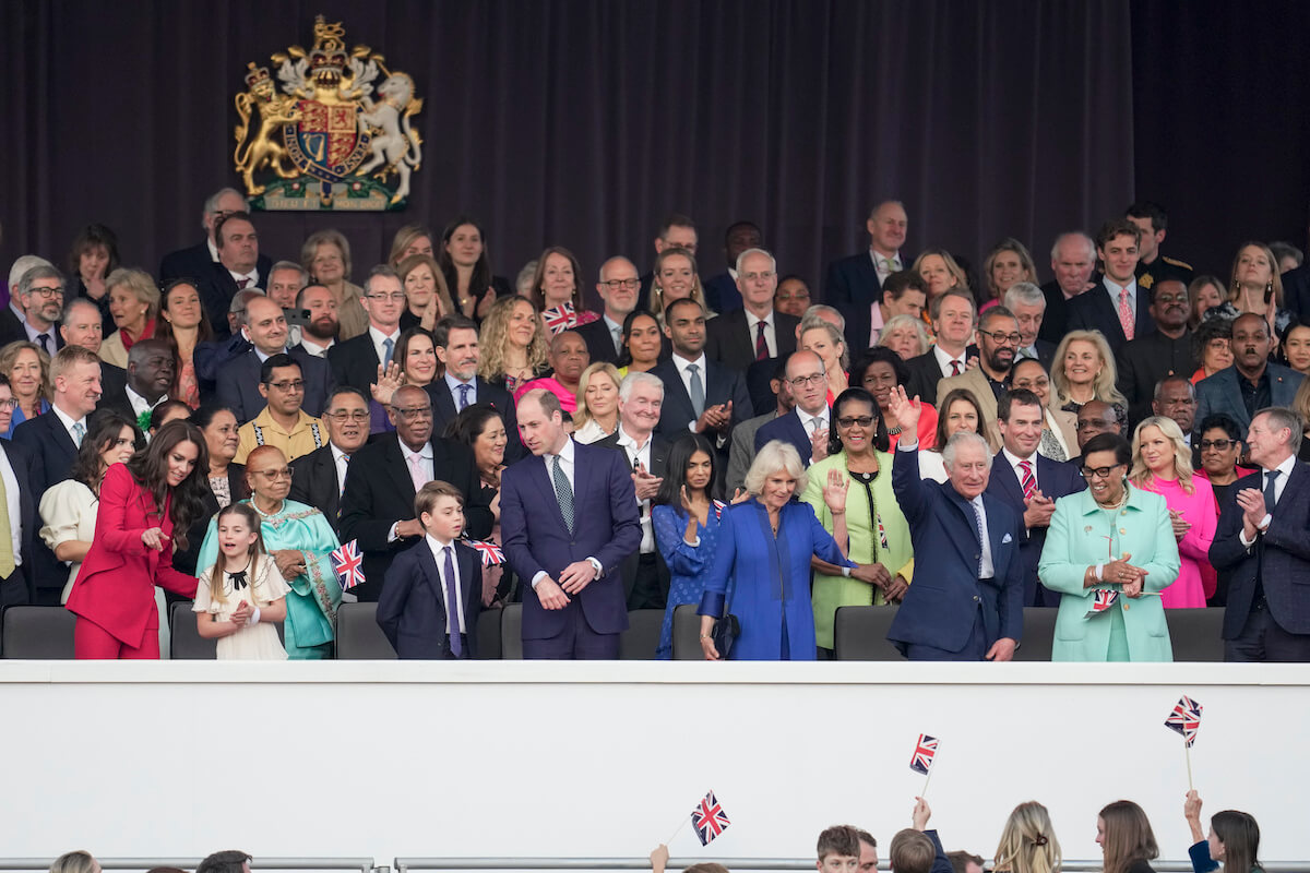 Kate Middleton, who had a 'priceless' reaction to Prince William's coronation concert joke, according to a body language expert, stands with Princess Charlotte, Prince George, Prince William, Queen Camilla, and King Charles III