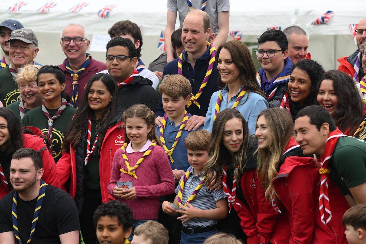 Kate Middleton, who's reportedly OK to start a 'rift' with King Charles over raising Prince George, Princess Charlotte, and Prince Louis, stands with Prince William and their children at a volunteering event