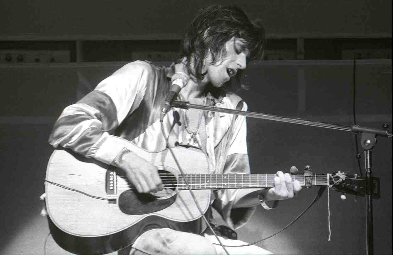 Keith Richards playing an acoustic guitar during a Rolling Stones concert circa 1973.