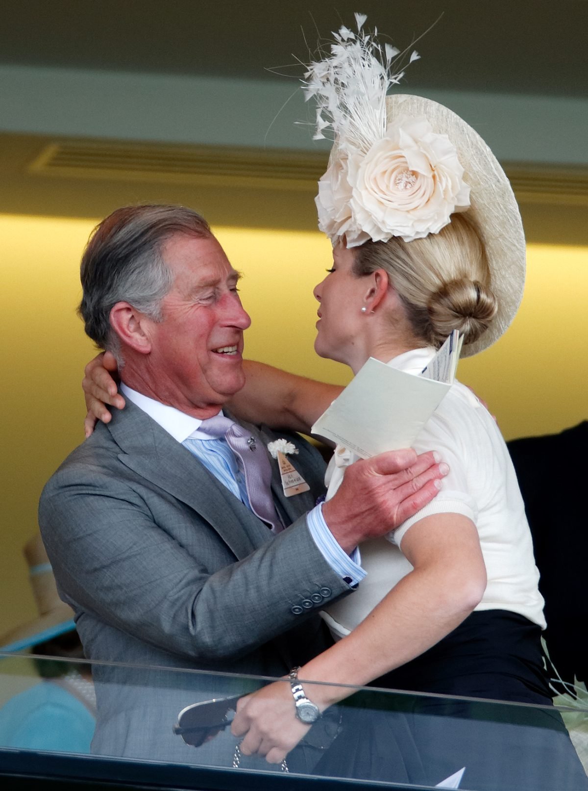 King Chalres and Zara Tindall greet each other with a hug as they attend day 1 of Royal Ascot