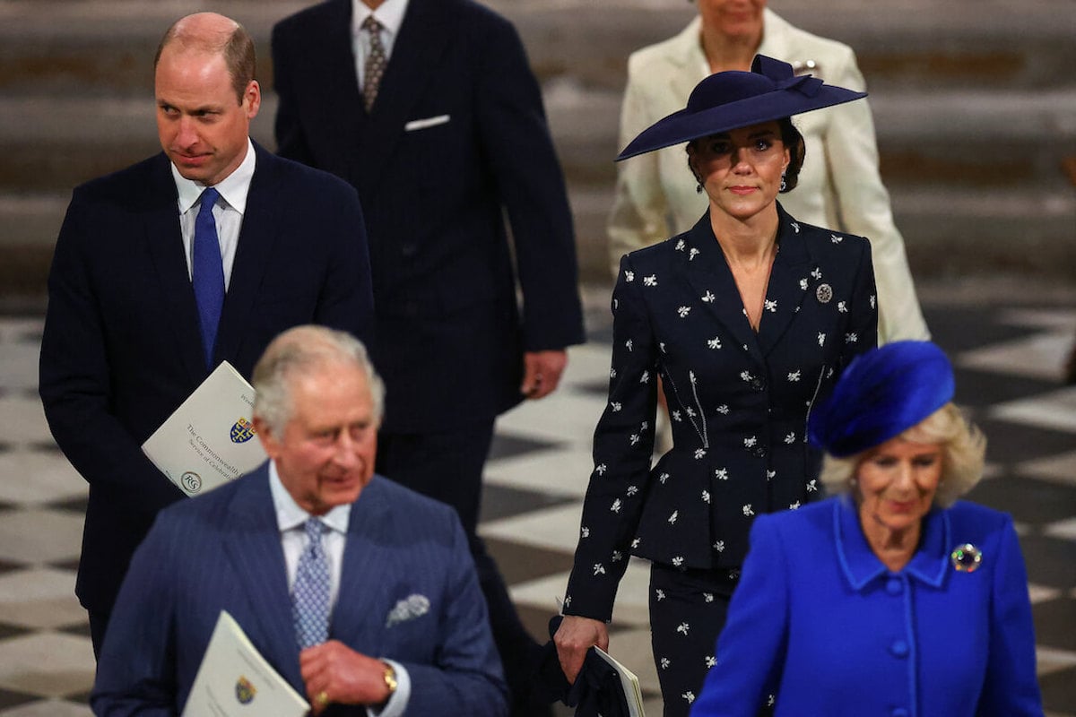 Kate Middleton, who bonded with King Charles and Queen Camilla, according to a biography, walks with Prince William, King Charles, and Queen Camilla