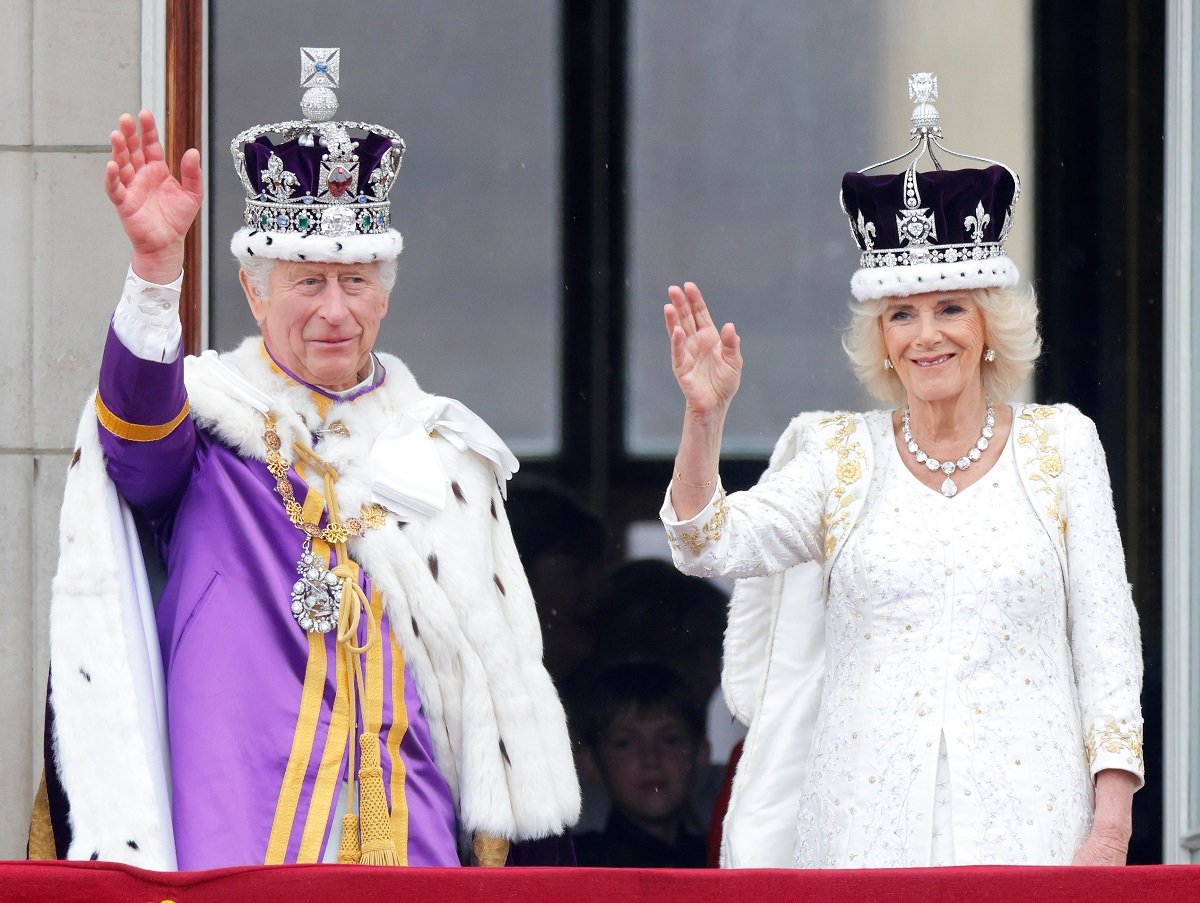 King Charles III and Camilla Parker Bowles waving from balcony before flypast