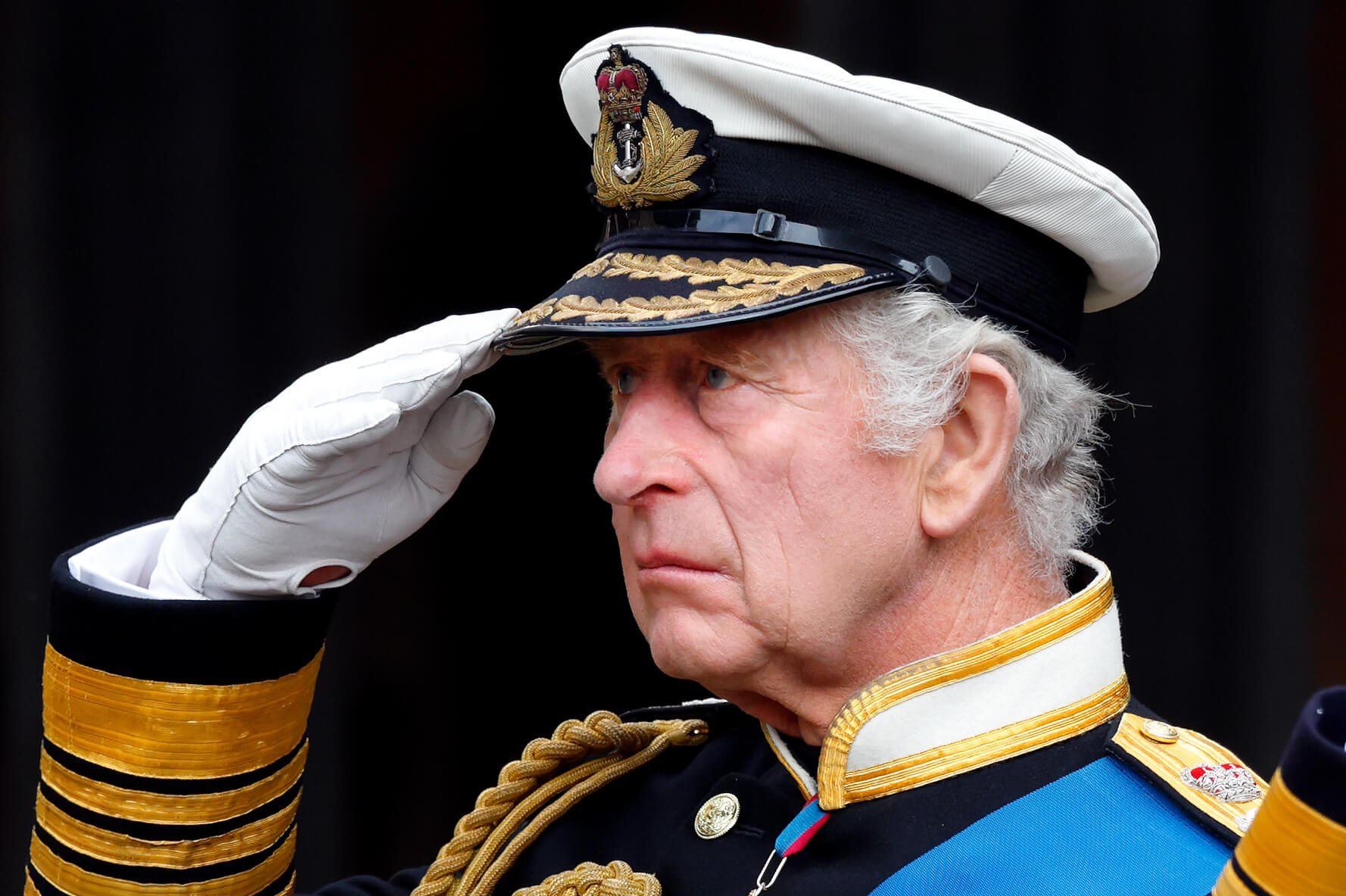 King Charles III saluting in uniform