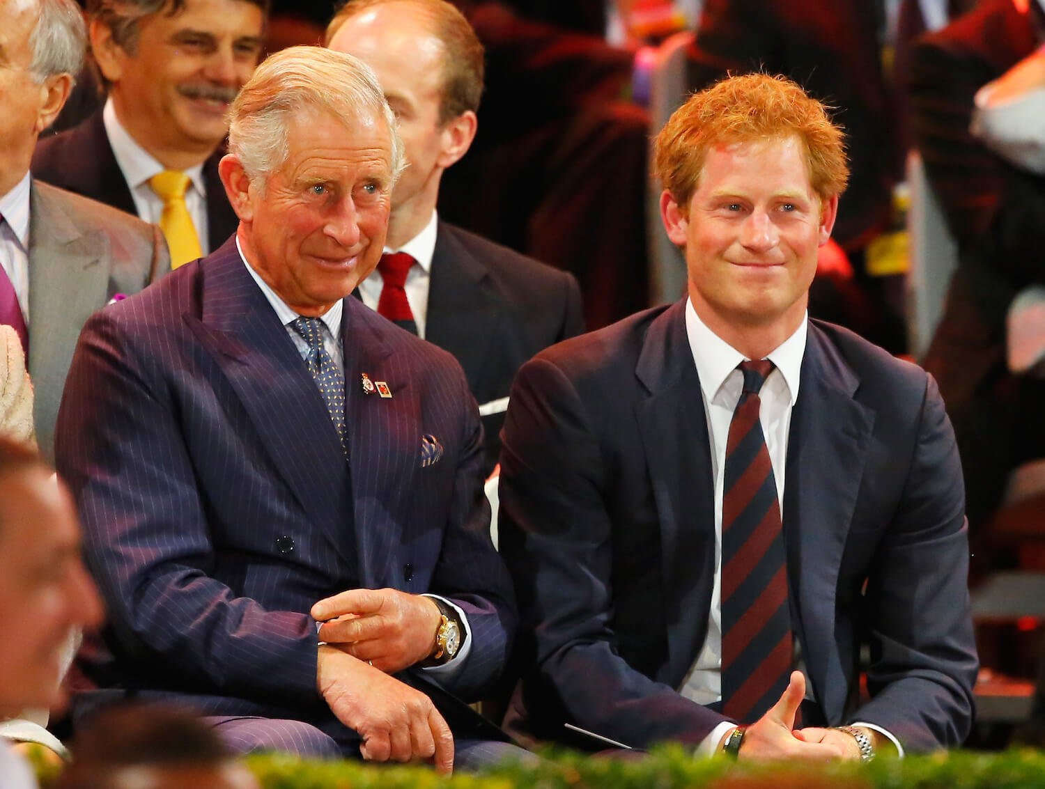 King Charles and Prince Harry sitting next to each other 