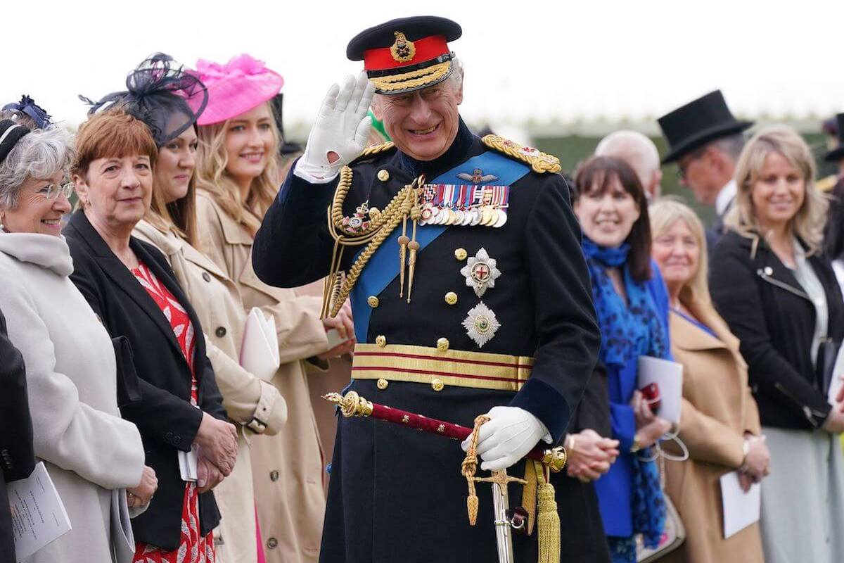 King Charles, who switched coronation crowns at his coronation ceremony, waves 