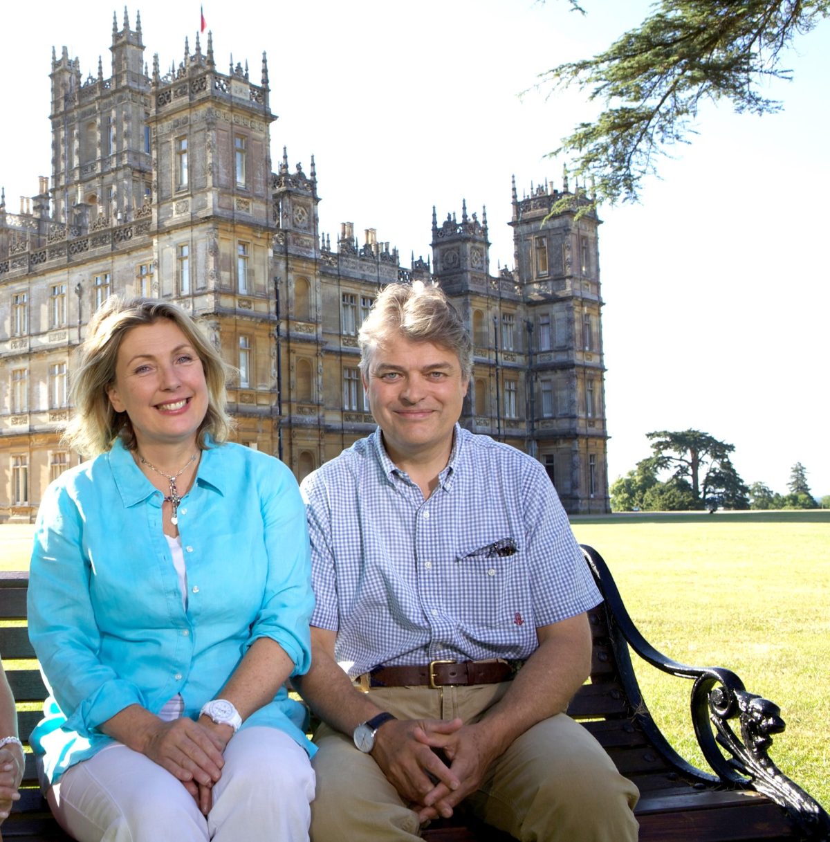 Lady Carnarvron and Lord Carnarvron pictured on bench in front of Downton Abbey