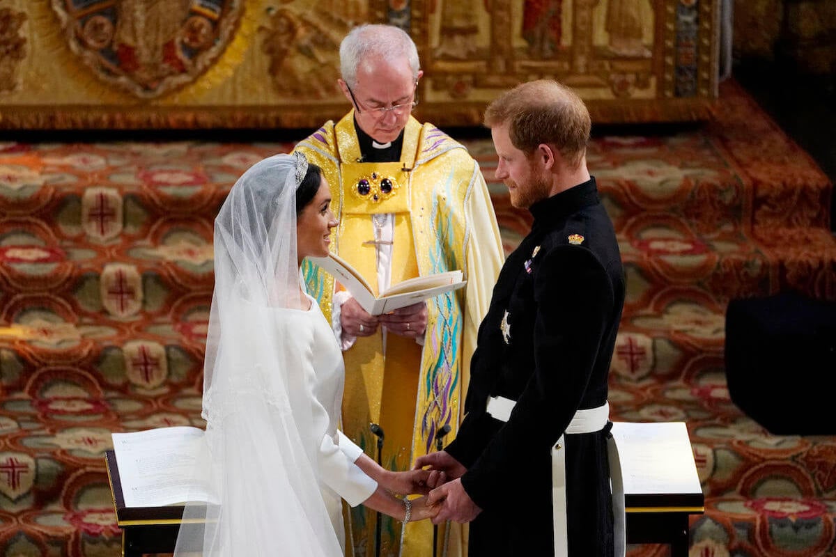 Meghan Markle and Prince Harry hold hands as they exchange vows during their 2018 royal wedding
