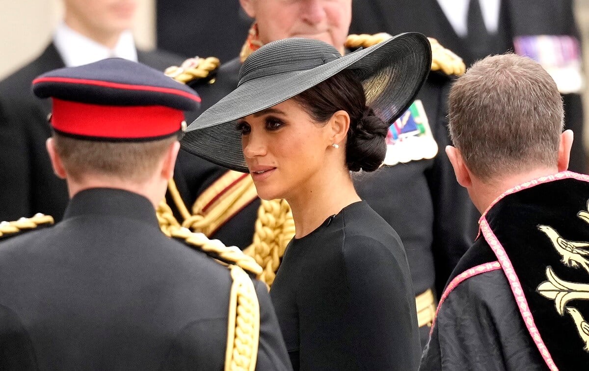 Meghan Markle, who King Charles' former butler says is making an important move not attending the coronation, arrives at Westminster Abbey for Queen Elizabeth II's funeral