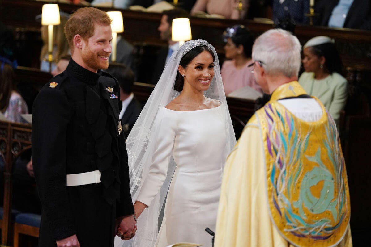 Meghan Markle, whose royal wedding body language showed 'strength,' stands with Prince Harry at their royal wedding
