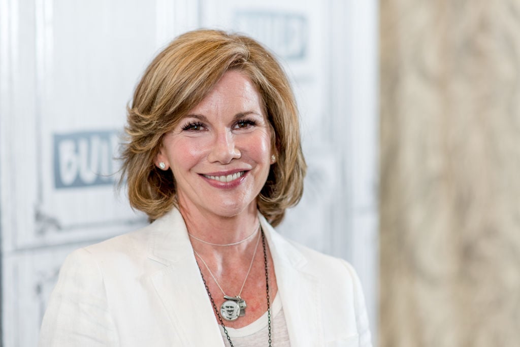 Melissa Gilbert smiles for the camera in a white shirt and jacket.