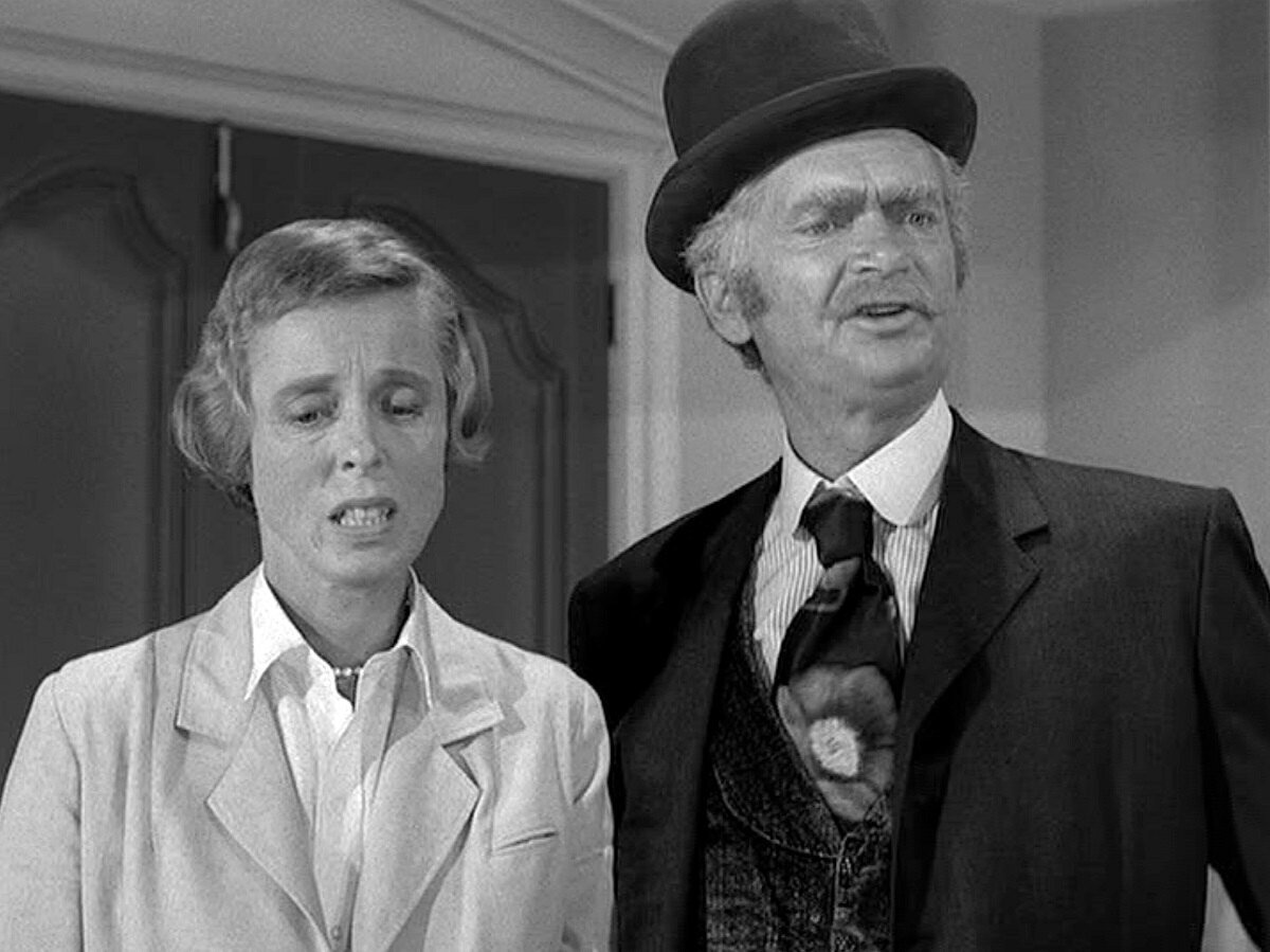 Nancy Kulp and Buddy Ebsen as Jane Hathaway and Jed Clampett stand together in an episode of 'The Beverly Hillbillies.' Their bitter fued bled over into politics years after the series ended.