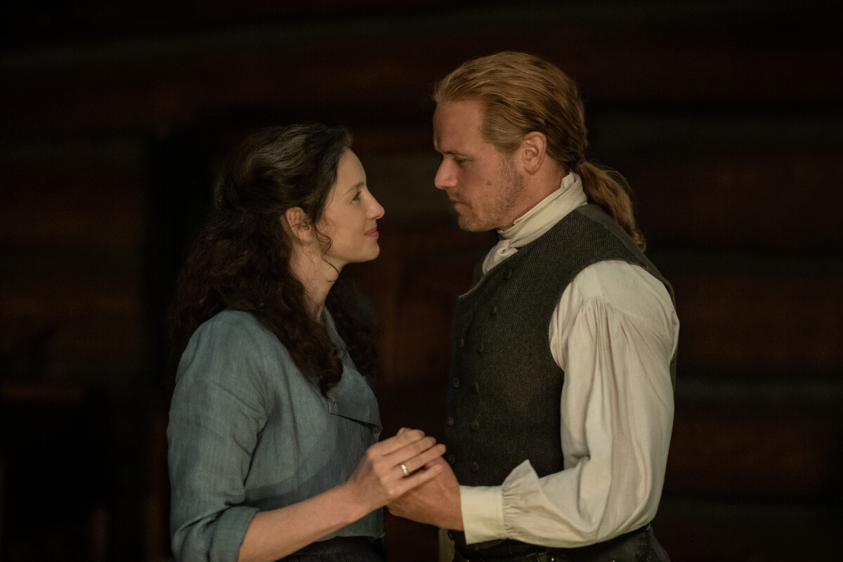 Outlander stars Caitriona Balfe and Sam Heughan as Jamie and Claire Fraser in an image from season 7