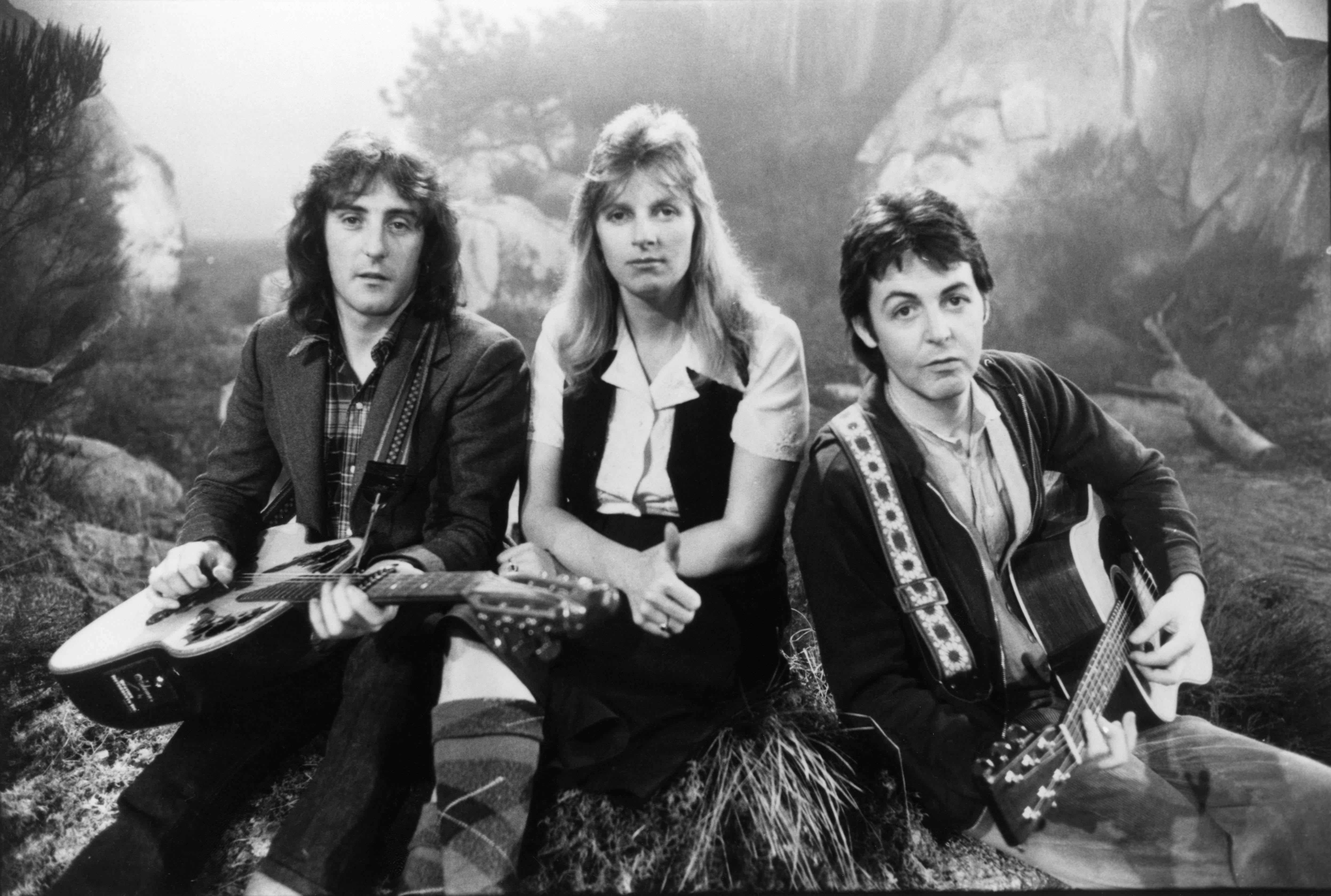 Denny Laine, Linda McCartney, and Paul McCartney of Wings pose for a photo