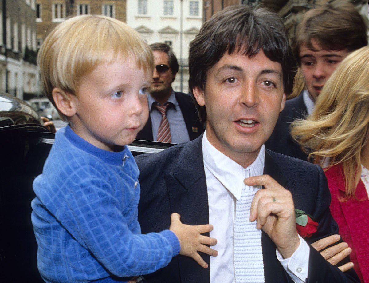 Paul McCartney holds his son James in 1981