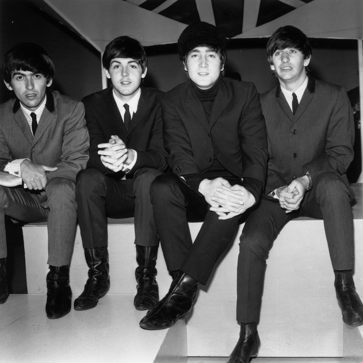 The Beatles sitting down in 1964