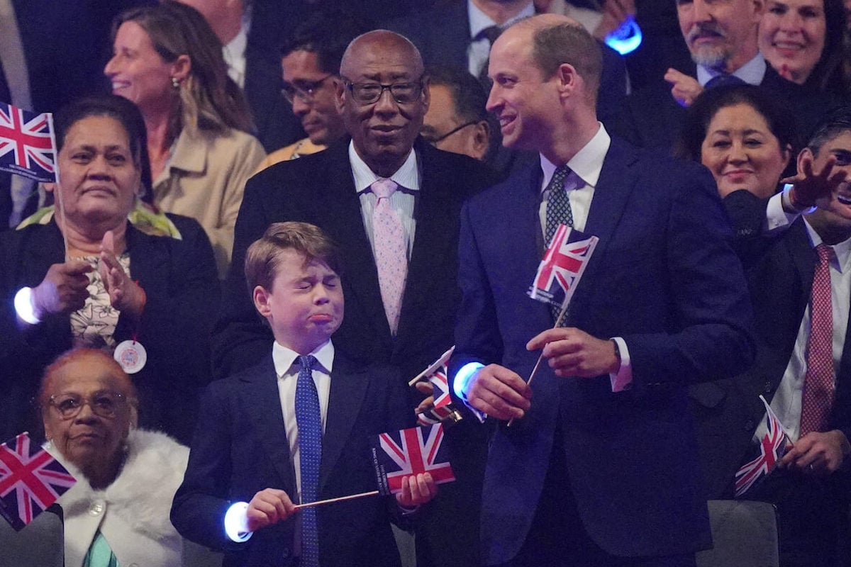 Prince George, who had memorable coronation weekend facial expressions along with Princess Charlotte and Prince Louis, stands next to Prince William at the coronation concert