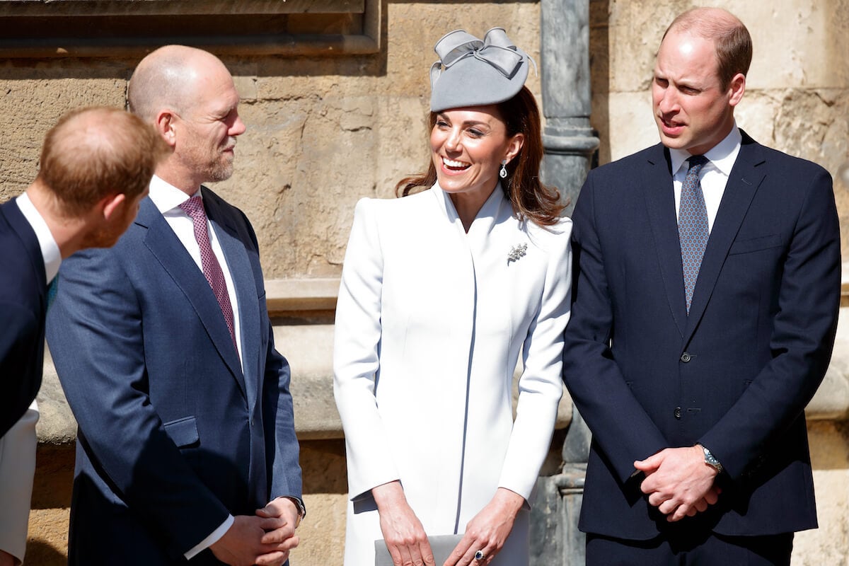 Prince Harry and Prince William, who, according to a body language expert saw Mike Tindall as a 'hero' before he joined the royal family, stand together with Kate Middleton