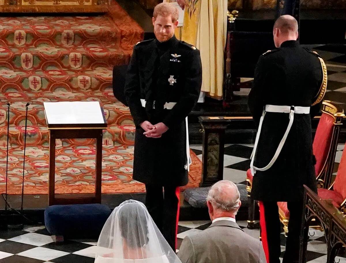 Prince Harry looks on as Meghan Markle and King Charles walk down the aisle