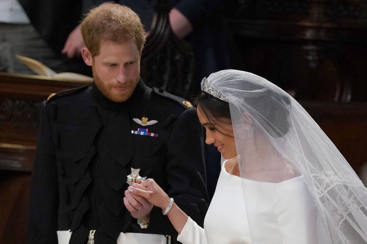 Prince Harry, who recalled what he thought as Meghan Markle walked down the aisle, stands with Meghan Markle at their royal wedding